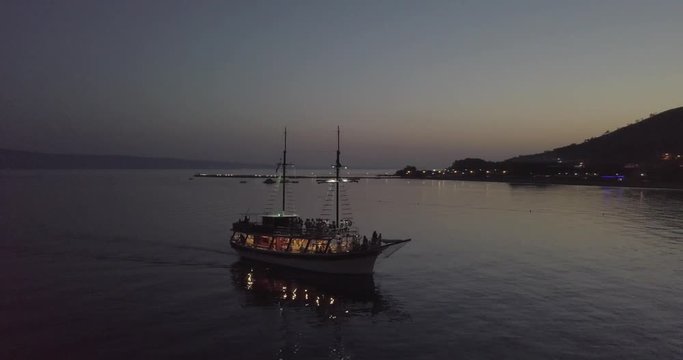 AERIAL: Old boat cruising in Croatia at dusk