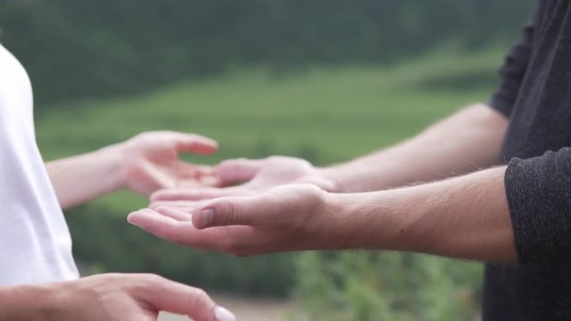 Close up of hands of a mature couple. Family relationships. Hand in hand against the backdrop of mountains. Tenderness of hands in love