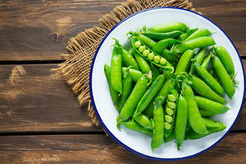 sweet peas on a wooden surface