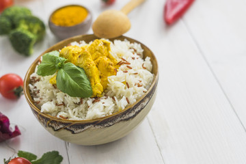 Delicious fried rice with basil leaves and chicken over white surface