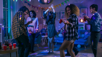 At the College House Party: Diverse Group of Friends Have Fun, Dancing and Socializing. Boys and Girls Dance in the Circle. Disco Neon Strobe Lights Illuminating Room.  - obrazy, fototapety, plakaty