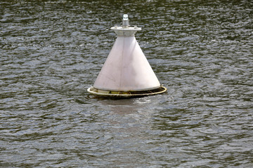 River navigation buoy on the surface of the water in the daytime