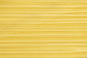 Closeup abstract pattern at yellow women's clothing textured background