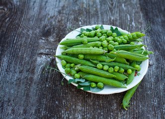 fresh pea on dark wooden surface