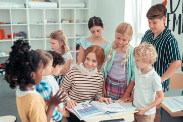 Teacher reading a book to her class.