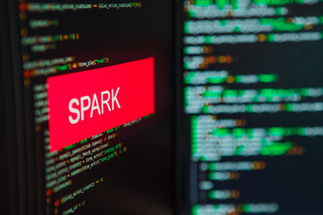 Programming language, Spark inscription on the background of computer code.