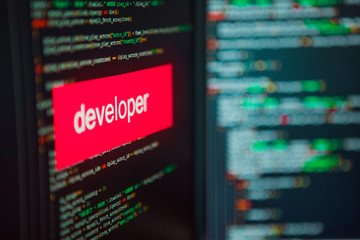 Programming and development, the inscription on the background of computer code.