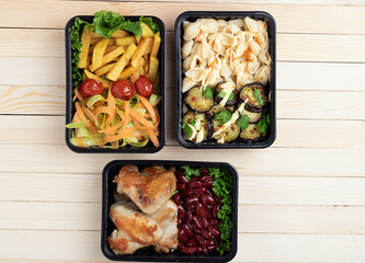 top view of ready meal into food containers, fried zucchini and eggplants, place for text