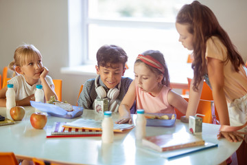 Children feeling good while spending time in canteen together