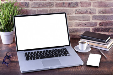 Laptop notebook with blank screen and cup of coffee and notepad pen and books and smartphone on wooden