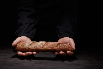 Baker man holding a beautiful round bread