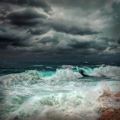 Stormy sea view  near coastline at evening time. Waves, splashed