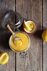 Lemon curd with ingredients on a rustic wooden table