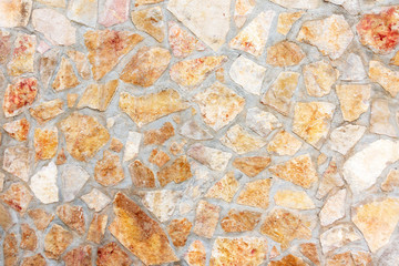 Masonry wall of stones with irregular pattern texture background