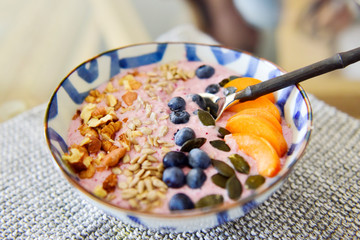 Healthy breakfast. Oatmeal porridge with fresh fruit and cranberries.
