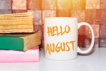 Hello August handwriting on coffee cup