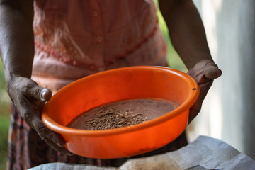 Orange large sieve sifted cinnamon. Mistress in Sri Lanka or India makes spices.