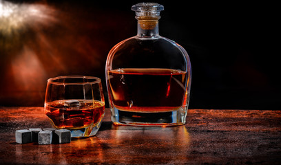 Bottle and glass of brandy with reusable ice cubes