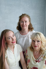 Three generations of women in the family in one photo. An adult daughter, her mother and grandmother. Beautiful old women, noble and beautiful old age. Family history