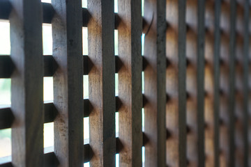 Beautiful wooden brown mesh. Lattice on the street. Stock photo background for design