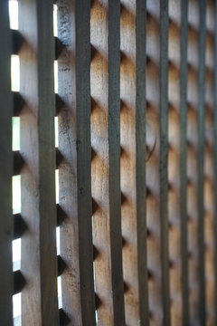 Beautiful wooden brown mesh. Lattice on the street. Stock photo background for design
