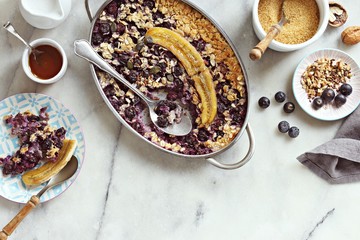 Super seedy vegan baked oatmeal with blueberries and caramelized banana. 