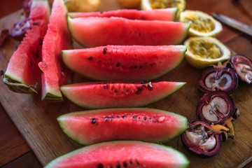 Different oriental vegetarian fruits on the table. Stock photography watermelon passion fruit