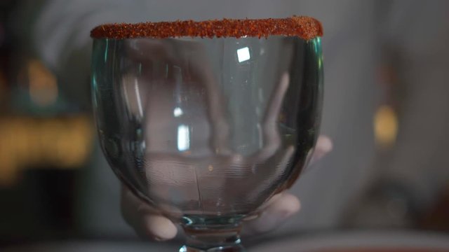 Michelada glass with chili and chamoy panning up