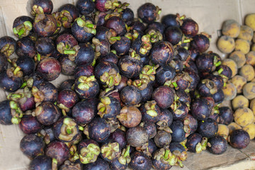 Beautiful harvest of mangosteen on the market in Asia. Vegetarian theme. Stock photo