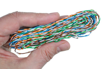 Elderly male technician holds in his hand a coil of computer twisted wire isolated