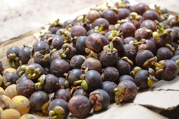 Beautiful harvest of mangosteen on the market in Asia. Vegetarian theme. Stock photo