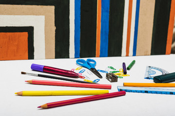 Stationery lying near abstract painting