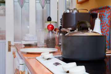 Cooking dinner at home in the kitchen, steam coming from under a saucepan lid