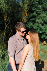 Fototapeta premium young couple in love on nature at sunset