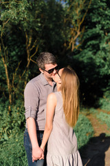 young couple in love on nature at sunset