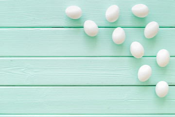 Blog pattern with eggs on mint green wooden background top view copyspace