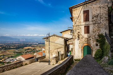 Panorama of the valley of the Sacco River, from a small square, in the ancient village of Artena. The Lepini mountains in the background. The outskirts of the city. Old stone wall and brick houses.