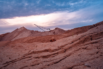 Coal mining at an open pit at sunset