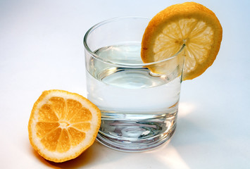 Glass of pure water with lemon isolated on a white background