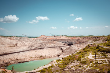 Fototapeta na wymiar Coal mining at an open pit in the daytime
