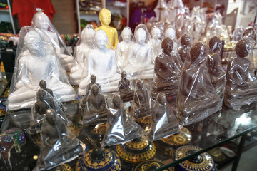 Souvenirs on the shelves of the market in Sri Lanka. Buddha figurines sold