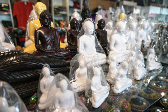 Souvenirs on the shelves of the market in Sri Lanka. Buddha figurines sold