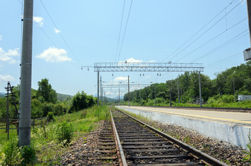 Fototapeta na wymiar Railway tracks in mountainous terrain extending into perspective