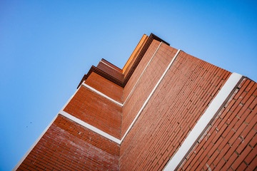 Building red brick house on sky background, bottom view