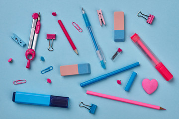 Colorful school supplies on blue background. Color background with various stationery items. Back to school.