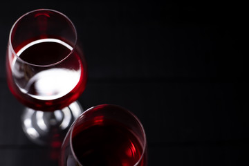 Red wine in glass on dark background.