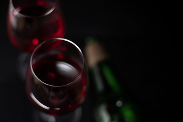Red wine in glass on dark background.