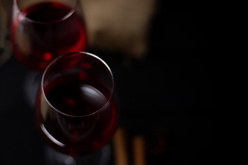 Red wine in glass on dark background.