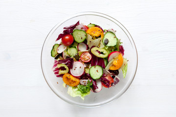 Spring salad with tomatos, sweet pepper, herbs, cucumbers, pumpkin seeds, etc