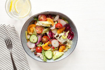 Vegan healthy salad on white table. Top view